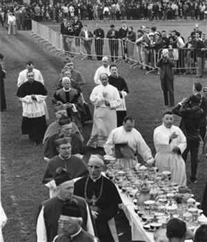 Priesters pakken kelken van tafels in het stadion van Straatsburg om de communie aan leden van de JOC uit te delen die in Straatsburg bijeen zijn voor de zogenaamde Eurorally; Foto Foto