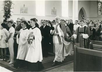 Op de dag van de viering van zijn 40-jarig priesterfeest betreedt pastoor van Welie de kerk. Bijschrift: "Zegen mij en mijn volk, Heer........"; Foto Foto
