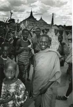 Uganda/Groepje mensen, op de achtergrond hutten.; Foto Foto