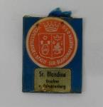 Reliekhouder houdende een afbeelding van zuster Blandine met een stukje textiel. Keerzijde houdende een onbekend schildvormig embleem met tekst: 'Vicepostulator c. beatif. sor. Blandinae Merten o.s.u.' en 'Sr. Blandine Ursuline v. Calvarienberg'; Reliekhouder Reliekhouder